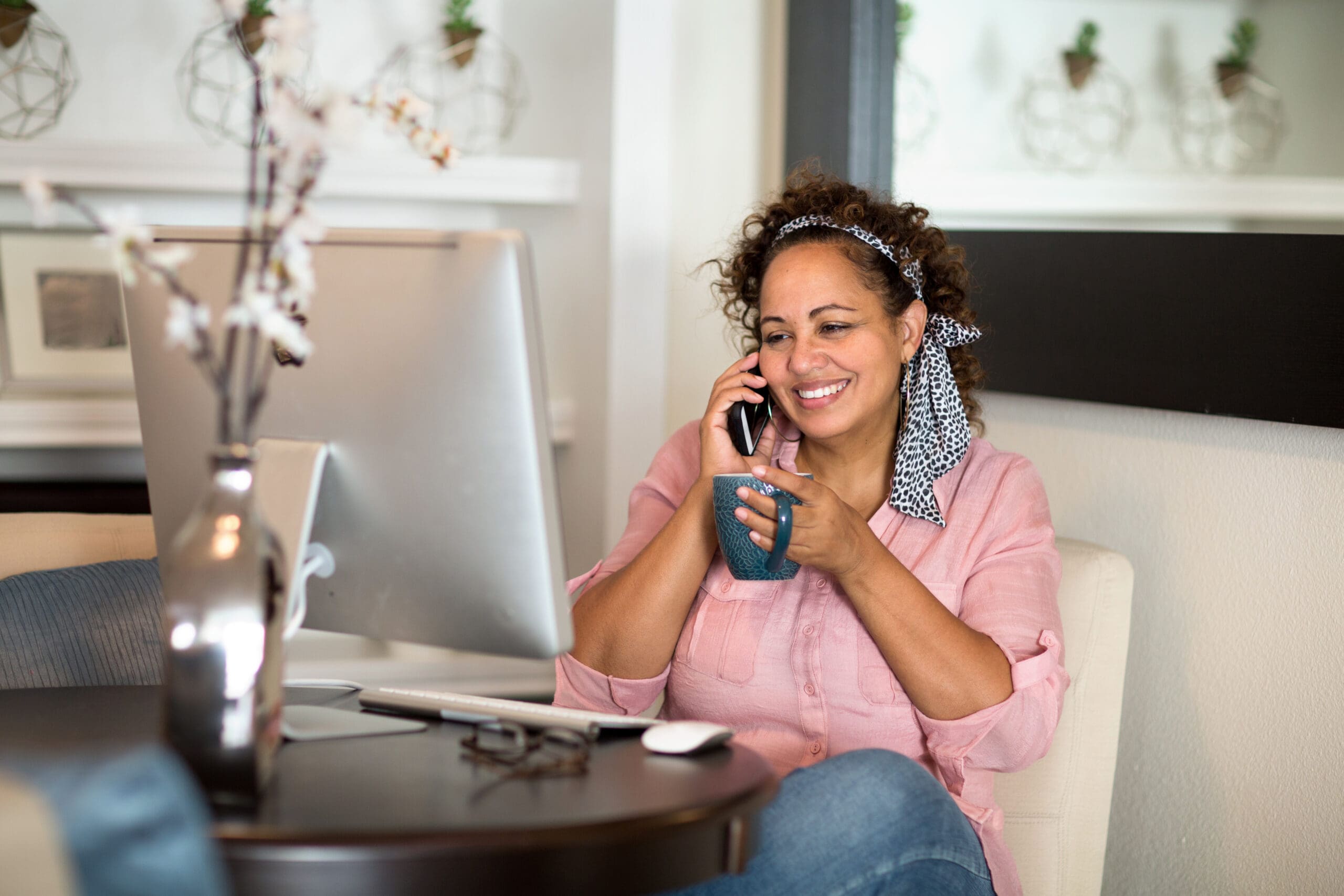Mixed race woman working from her home office.